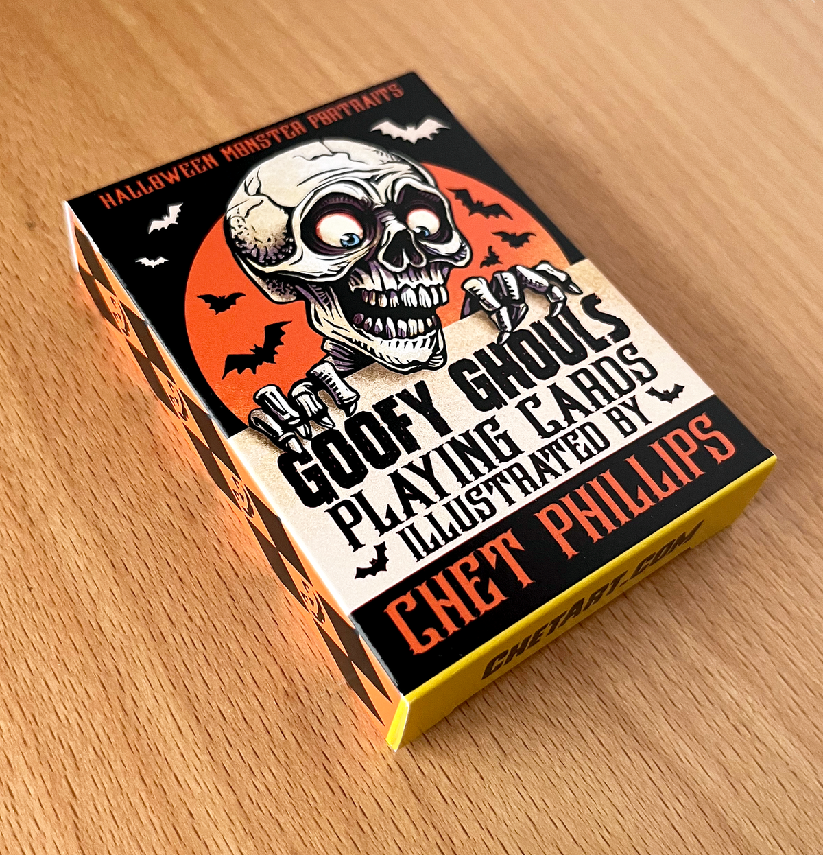 Card deck packaging with a skull design on a wooden surface