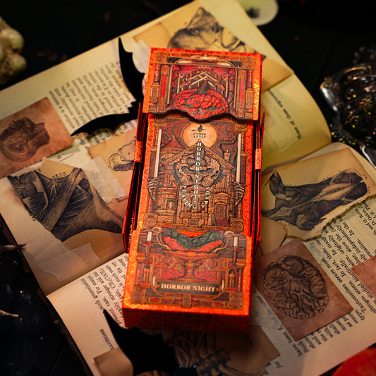 Decorative box with Halloween-themed design on an open book with illustrations.