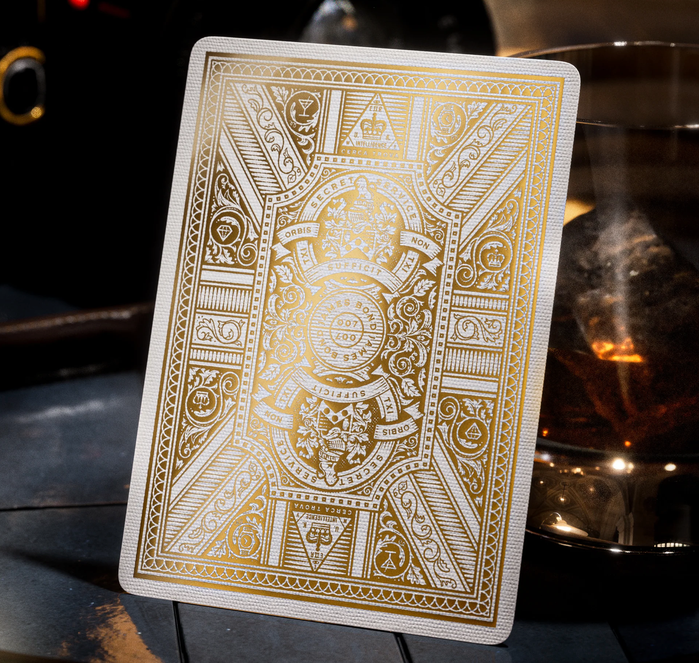 Decorative playing card with intricate gold design on a dark background