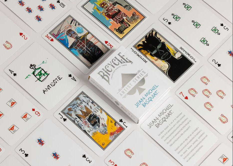 Bicycle playing cards with unique designs on a white surface