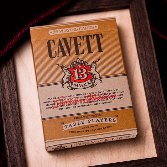 Cavett playing cards in a wooden box with a dark background
