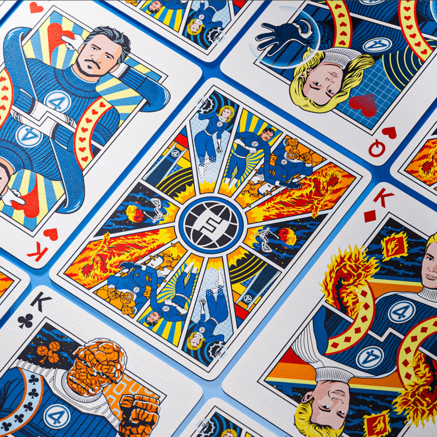 Playing cards with superhero design on a blue and white background