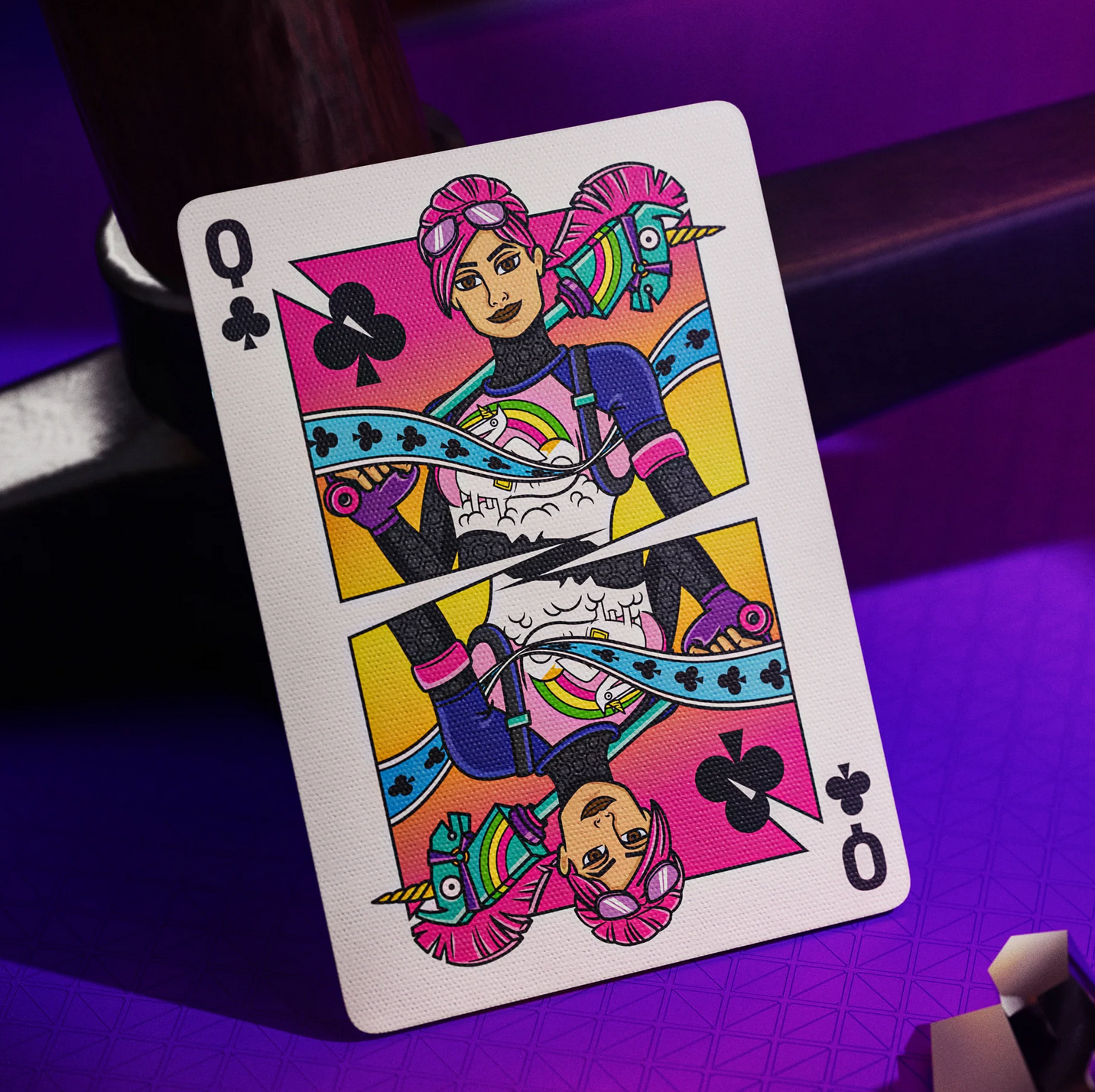 Playing card with a colorful design of a person with a unicorn horn on a purple background