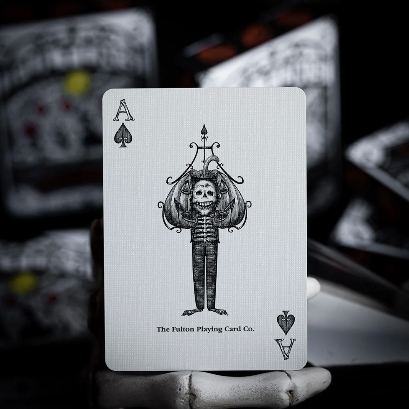 Playing card with a skeleton design and 'The Fulton Playing Card Co.' branding.