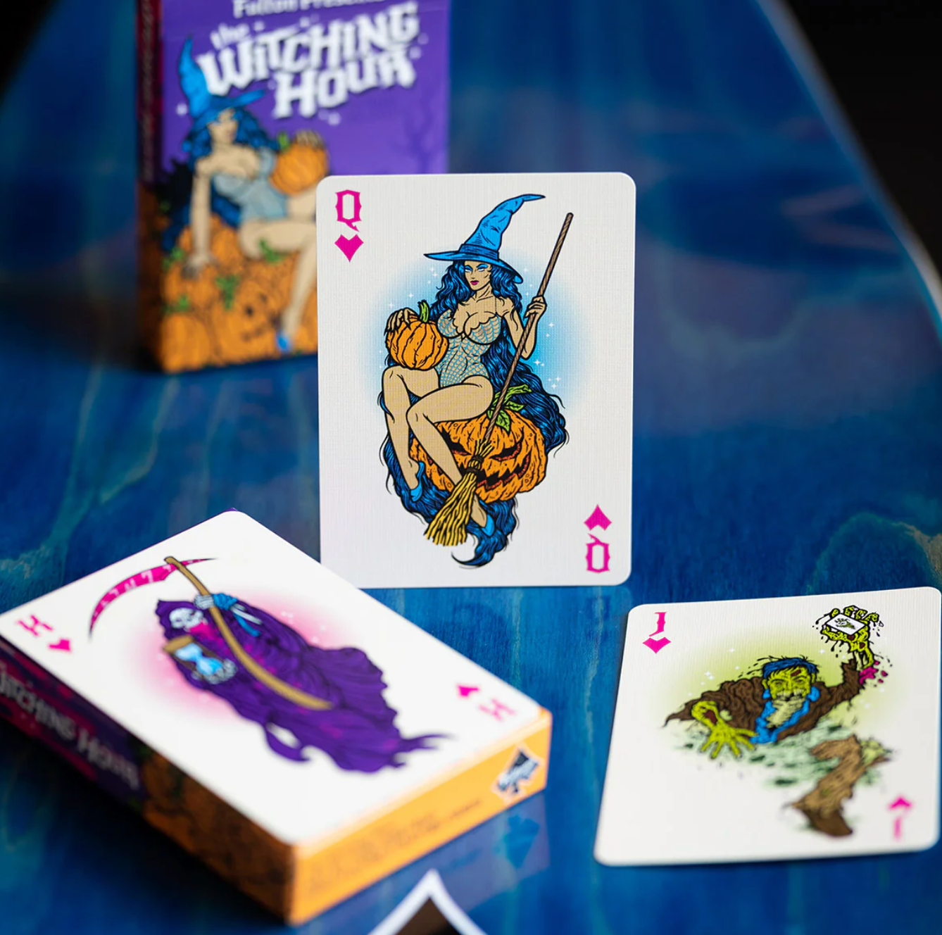 Witching Hour playing cards with a witch card on a blue surface