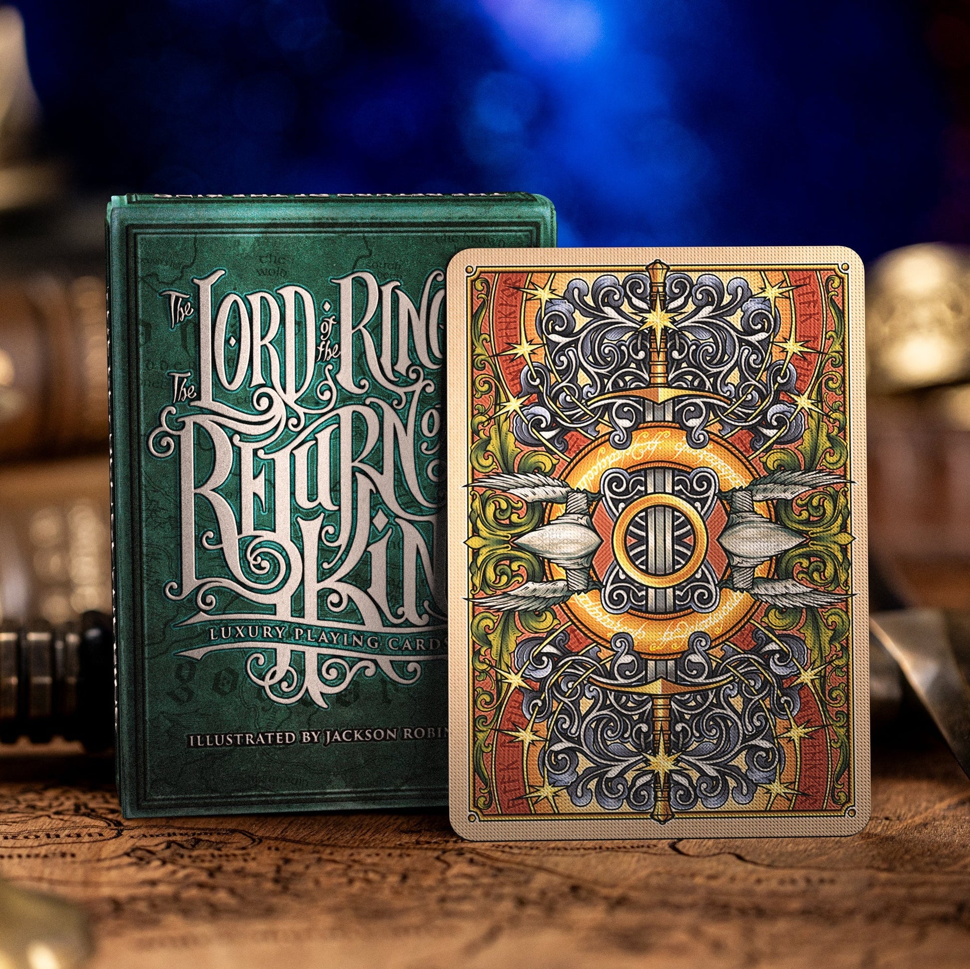 Lord of the Rings playing cards with ornate design on a wooden surface.