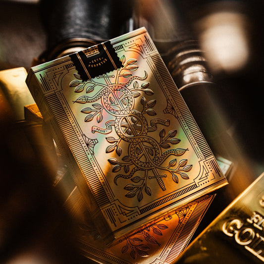 Gold playing cards with intricate designs on a blurred background 