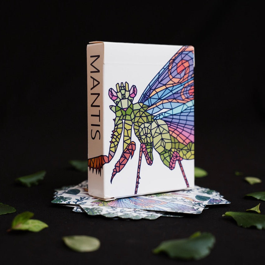 Mosaic Mantis Playing Cards house in a white box with a colorful stained-glass-style mantis illustration and the word "MANTIS" printed vertically on the spine.