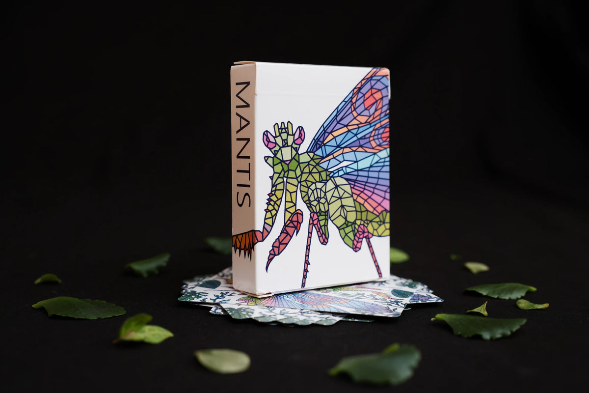 Mosaic Mantis Playing Cards housed in a white tuck box with a colorful stained-glass-style mantis illustration and the word "MANTIS" printed vertically on the side of the box.