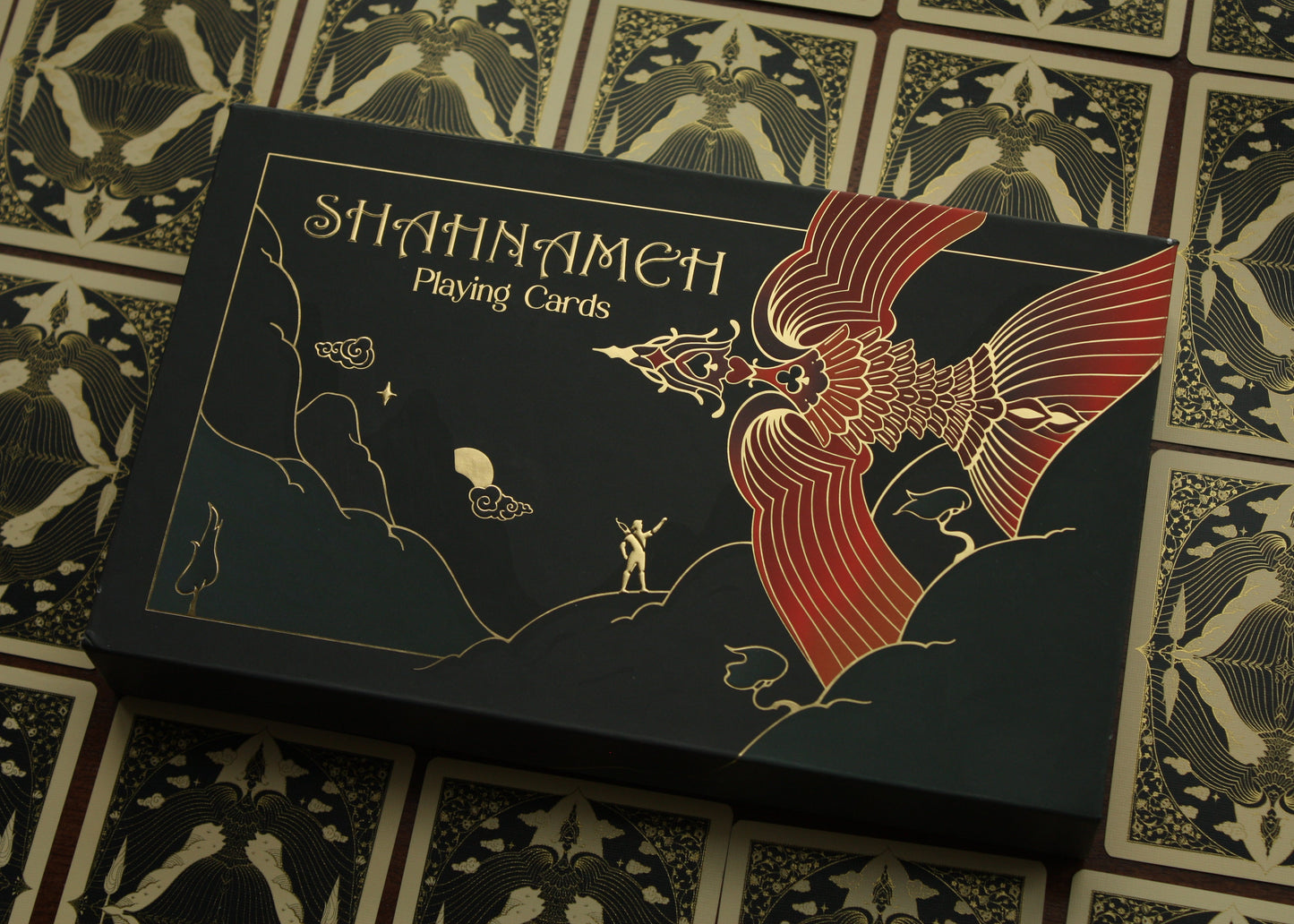 Shahnāmeh playing cards packaging with intricate design on a patterned background