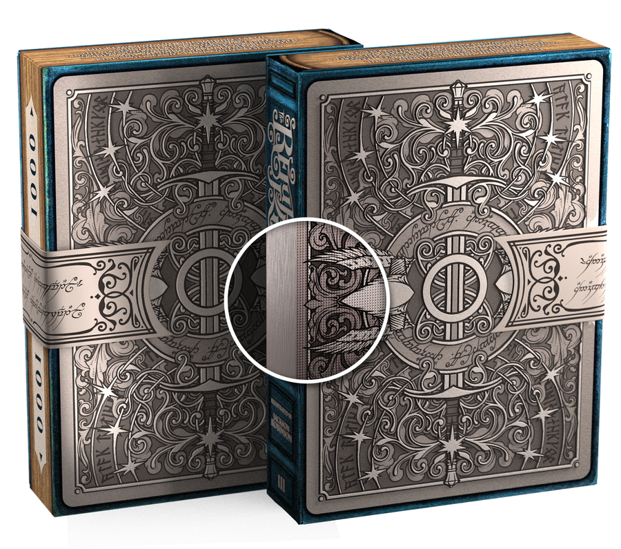 Two playing card boxes with intricate designs on a white background