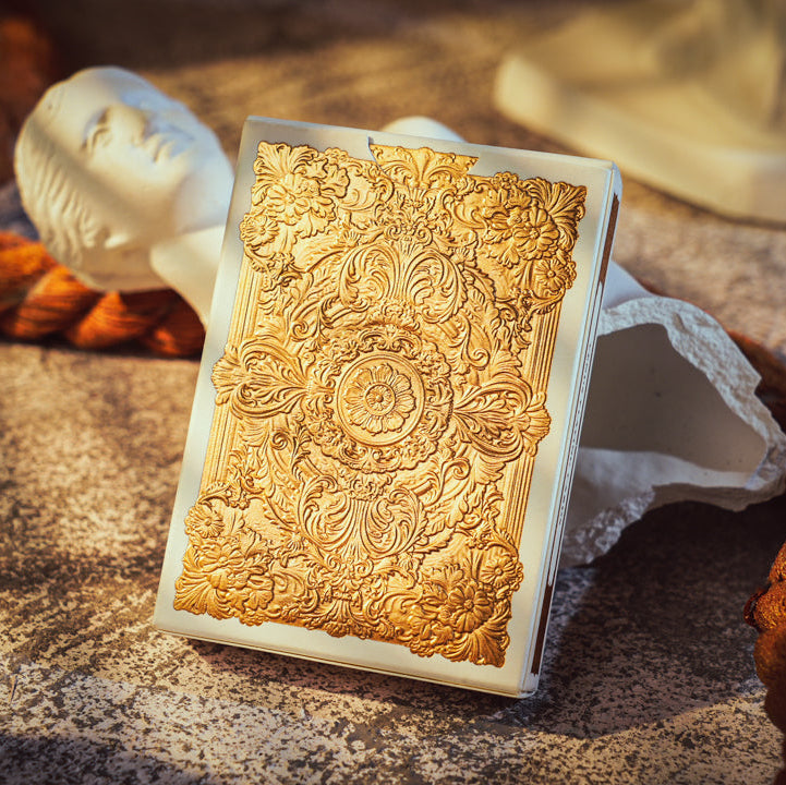 Decorative gold box with intricate patterns on a textured surface