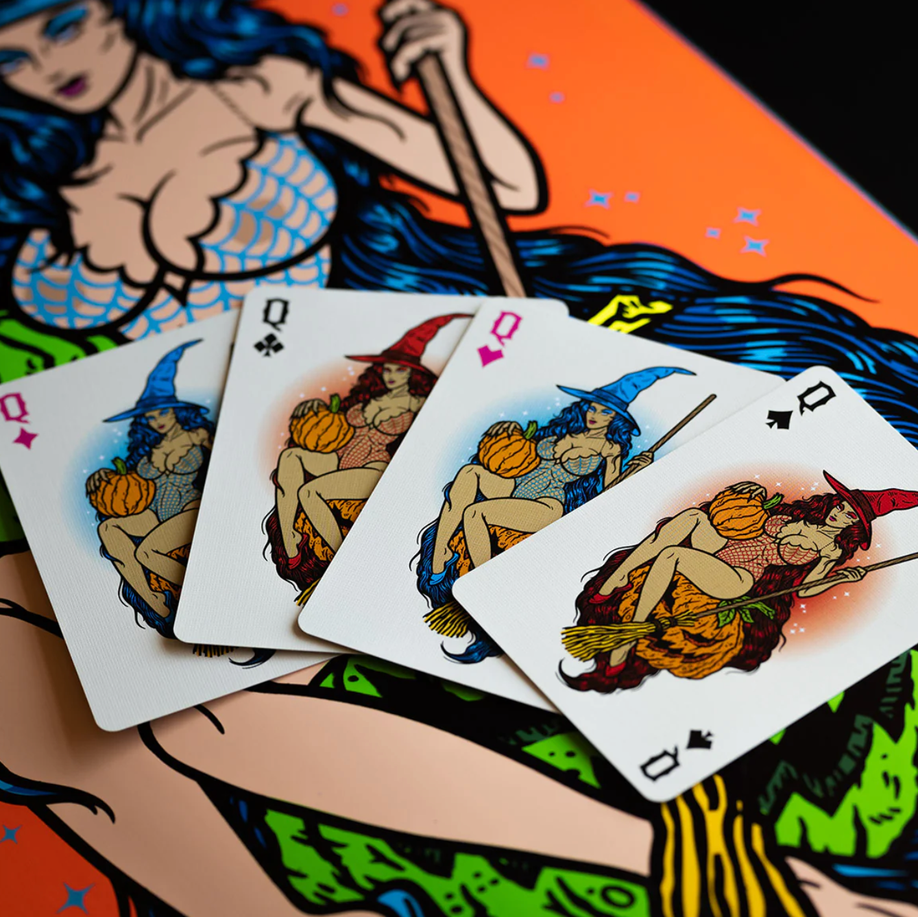 Playing cards with witch illustrations on a colorful background