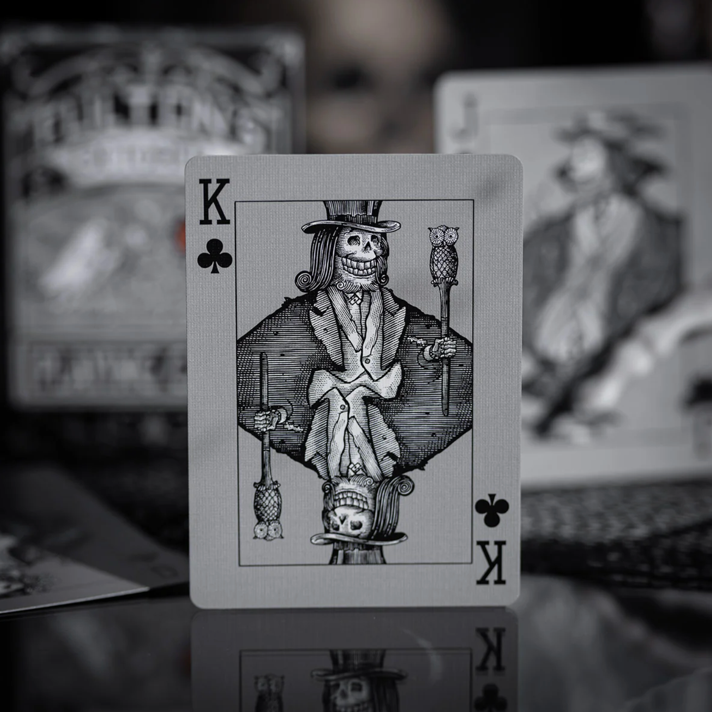 Playing card with a skeleton king of clubs design on a blurred background